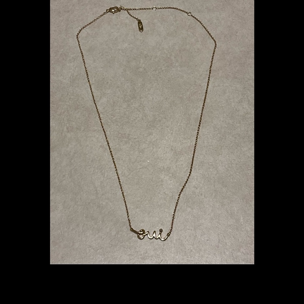 Gold toned necklace with cursive script French word “Oui”, 15-19”, like new!